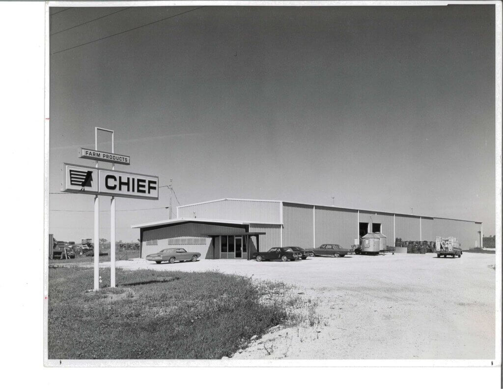 Black and white photo of the Chief Industries building with a large “Chief Farm Products” sign, marking the company's transition from Big Chief of Nebraska, Inc.