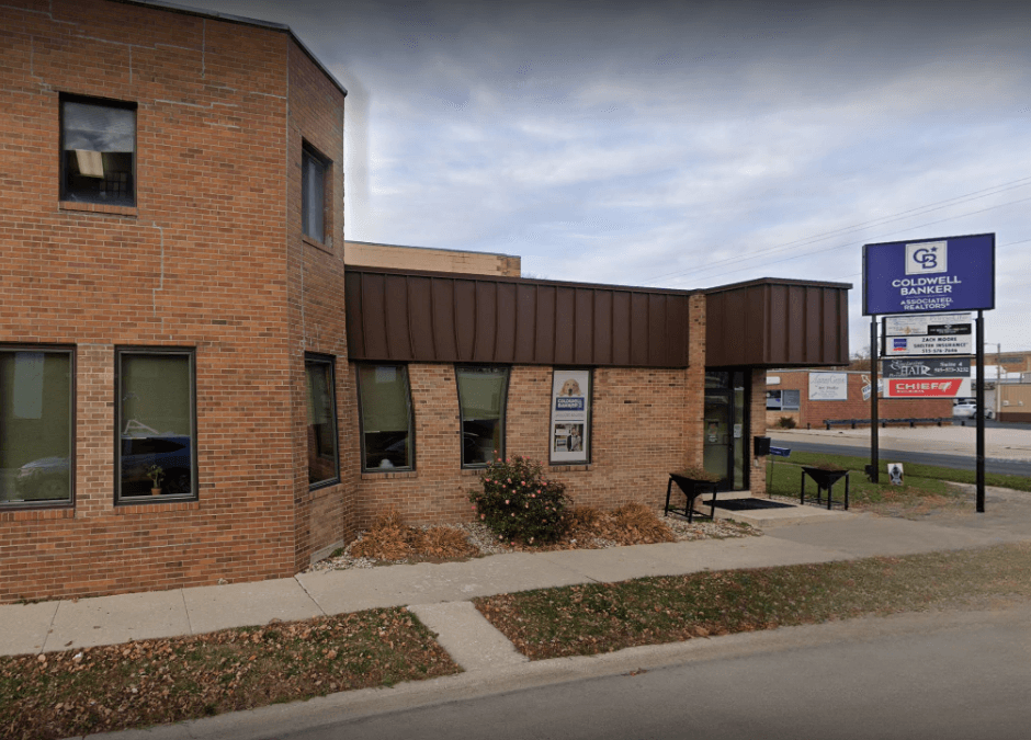Street-level view of Chief Buildings’ office location in Fort Dodge, Iowa, with a brick building, visible signage, and nearby businesses.